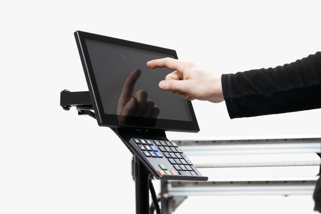 A hand touching the screen of an expandable interface