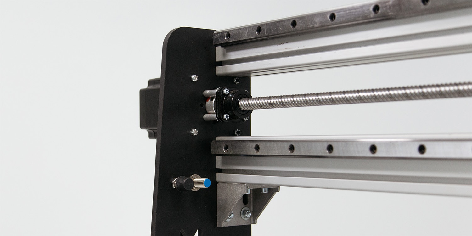 Close up on the X-axis assembly showing the ballscrew, the rails and the motor