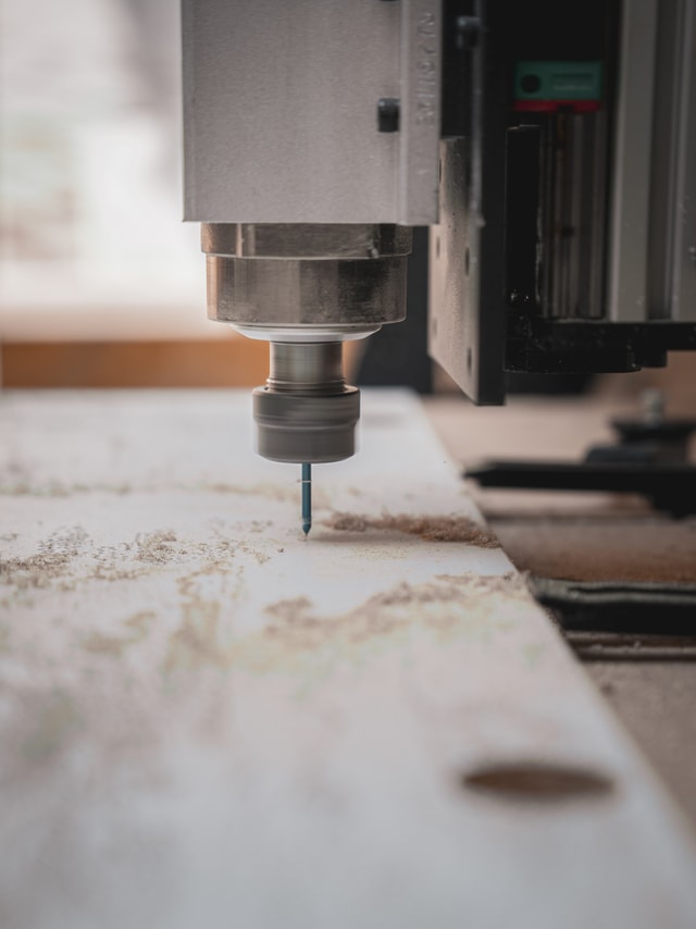 close-up on a CNC milling machine milling OSB