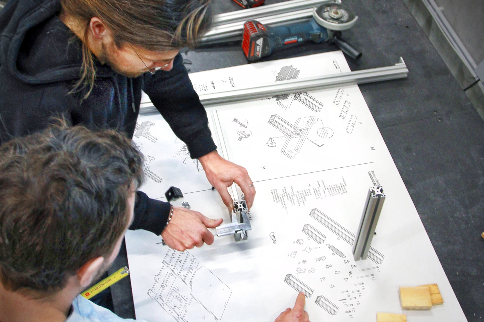 Mekanika employees assembling a part of the CNC